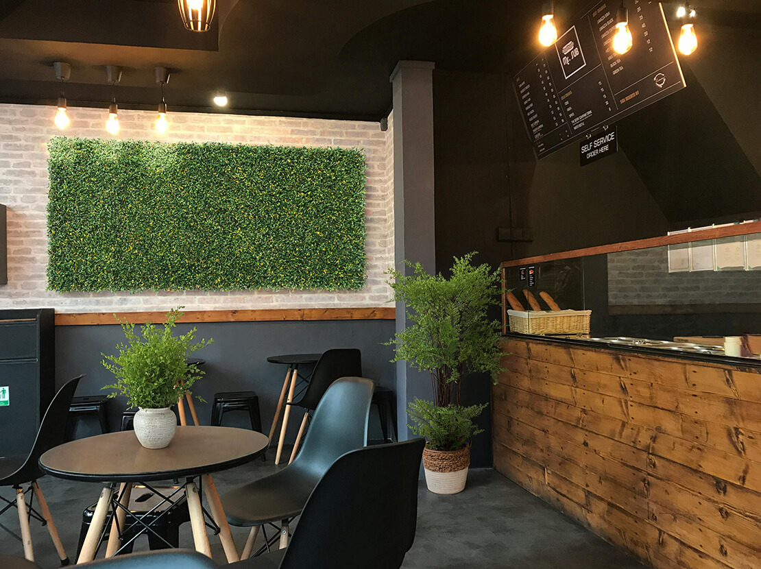 Food venue artificial foliage wall plants.